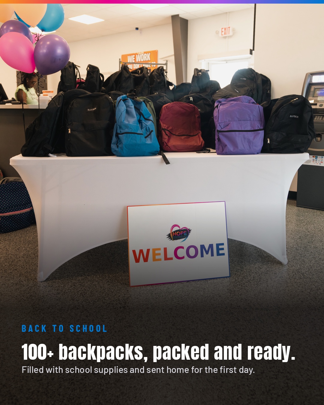 Backpacks filled with school supplies displayed at the Day of Hope welcome table.