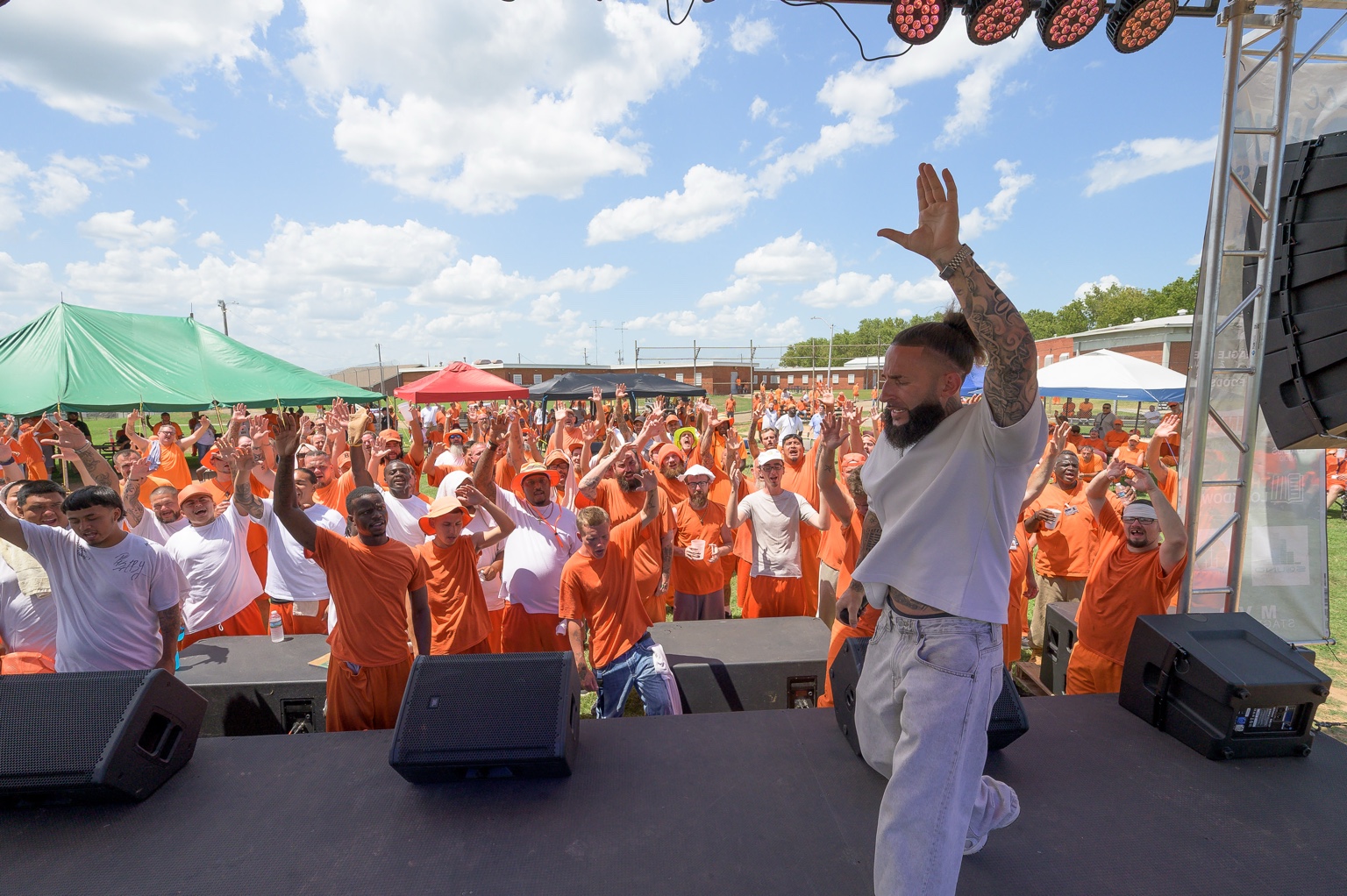 A Muzik Fest performer facing a large, engaged crowd from the stage